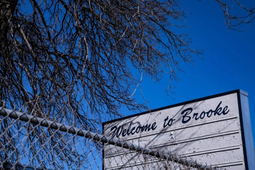 Paint peels from the school sign at the former Brooke Elementary School.