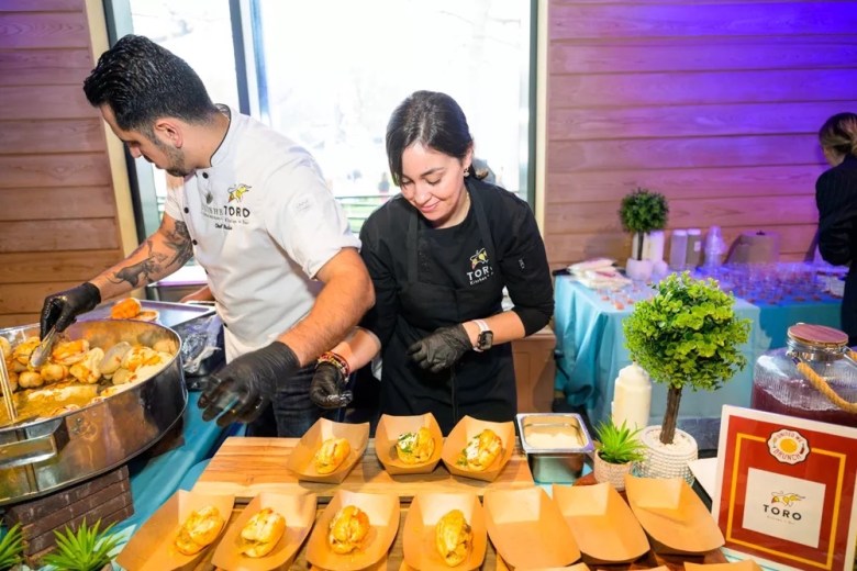 Toro Restaurant + Bar employees serve up delights at a previous United We Brunch. 