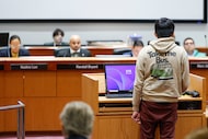 A speaker wears a hoodie that reads “Take the Bus” during public comment of a special-called...