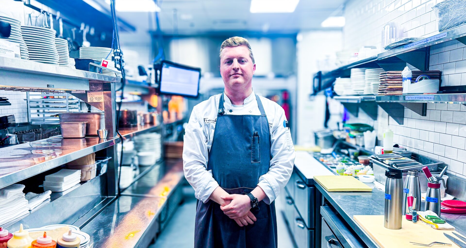 Chef Reilly Brown standing in his kitchen at Frenchie.