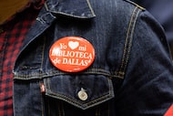 An audience member wears a button supporting the Dallas Public Library  as library director...