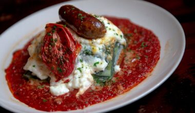 U.S. Health and Human Services Secretary Robert F. Kennedy Jr., center, helps serve lunch with cafeteria manager Samantha Atkins-Estrada and Austin ISD Executive Director of Food Service and Warehouse Operations Ryan Mikolaycik during a tour of the kitchen at Cunningham Elementary School in Austin on Friday, Feb. 27, 2026. Kennedy visited the campus to discuss federal dietary guidelines and nutrition policy.