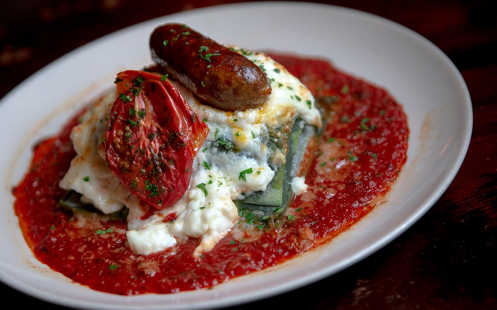 U.S. Health and Human Services Secretary Robert F. Kennedy Jr., center, helps serve lunch with cafeteria manager Samantha Atkins-Estrada and Austin ISD Executive Director of Food Service and Warehouse Operations Ryan Mikolaycik during a tour of the kitchen at Cunningham Elementary School in Austin on Friday, Feb. 27, 2026. Kennedy visited the campus to discuss federal dietary guidelines and nutrition policy.