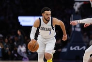 Dallas Mavericks' Tyus Jones controls the ball against the Minnesota Timberwolves during the...