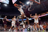 Texas guard Julian Larry (1) drives to the basket against Texas A&M forward Pharrel Payne...