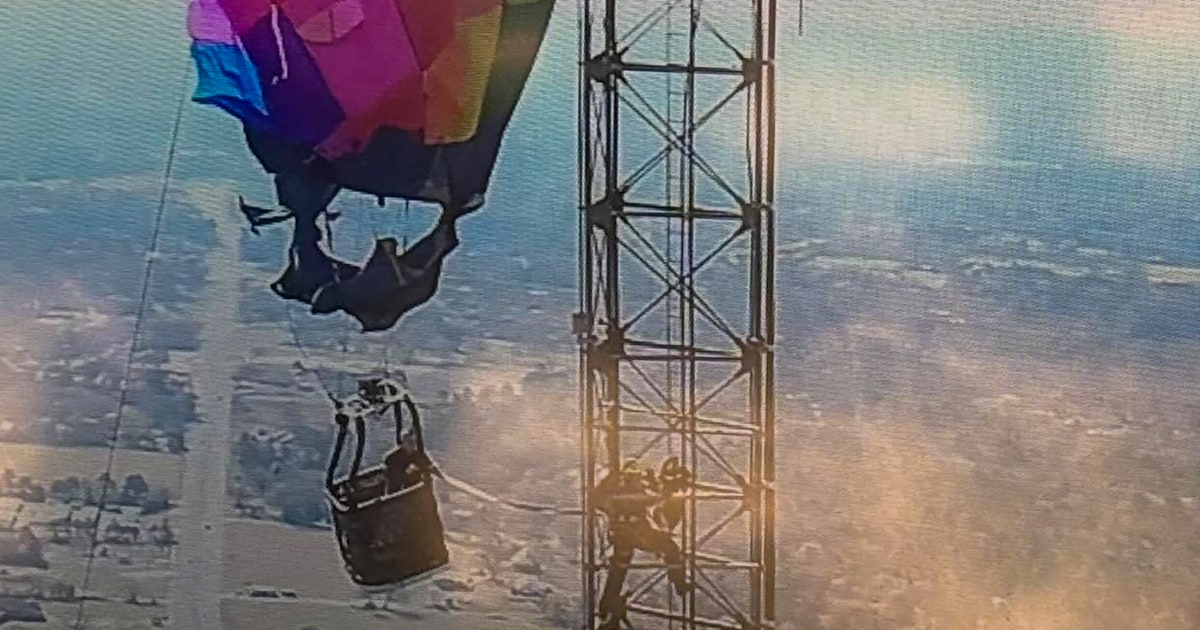 Two passengers rescued after hot air balloon crash into Texas cell tower leaves them dangling 920 feet up