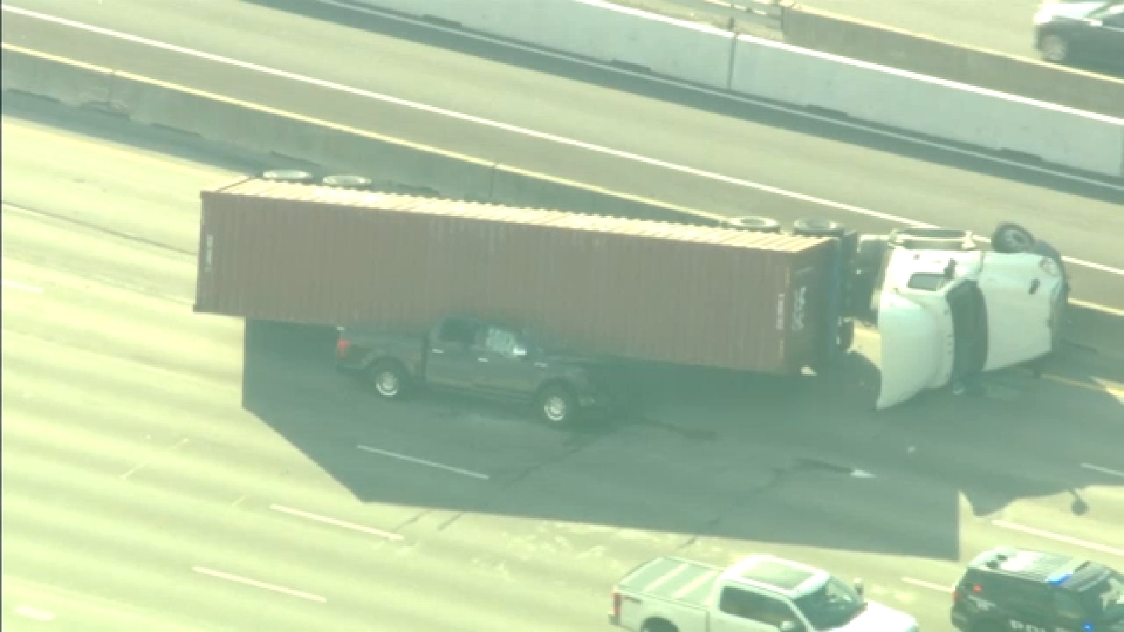 Southwest Freeway outbound lanes shut down after truck seen smashed beneath 18-wheeler near Chimney Rock