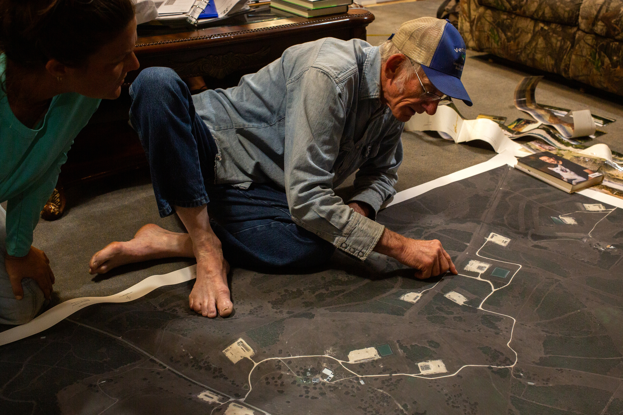 Blake Muir studies satellite imagery of oil wells on his Gonzales County ranch in July 2025. Credit: Dylan Baddour/Inside Climate News