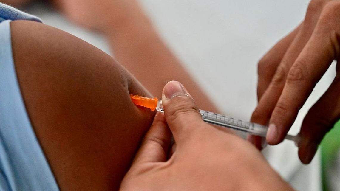 A nurse from the Ecuadorean Ministry of Health vaccinates a person against whooping cough in Guayaquil, Ecuador on May 8, 2025.  (Photo by MARCOS PIN / AFP) (Photo by MARCOS PIN/AFP via Getty Images)