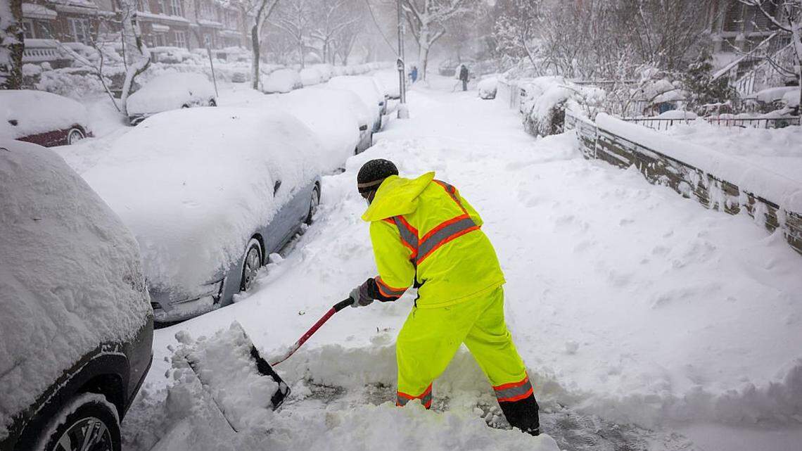 People shovel snow in the streets of Brooklyn as blizzard conditions continue on Monday, Feb. 23, 2026, in New York City. New York City Mayor Zohran Mamdani announced a state of emergency yesterday for New York City and issued a travel ban until 12 p.m. on Monday. New York City is expecting well over a foot of snow in what has become one of the largest winter storms in the city's history.