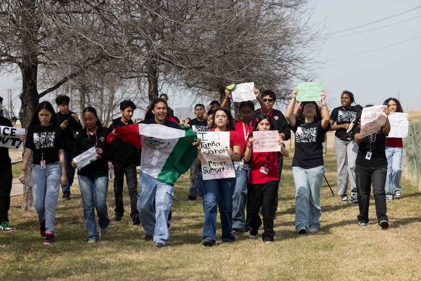 Dallas Environmental Science Academy Middle School students chant as they approach Margaret...