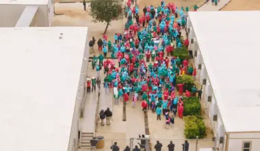 File - Immigrants seeking asylum walk through the ICE South Texas Family Residential Center in Dilley, Texas.