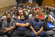 Attendees listen to public comments during a meeting with the city’s public safety and...