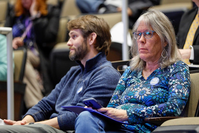 People wear stickers that read “Yes DART” during a Plano City Council meeting, Monday, Feb....
