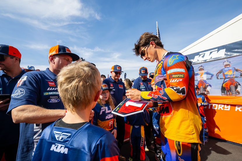 A rider signs autographs at a Monster Energy AMA Supercross FanFest event.
