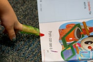 A student points to a word while reading during kindergarten teacher Lyndsey Williams’ class...