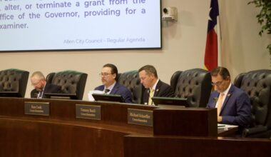 council members sitting at a dais during a meeting