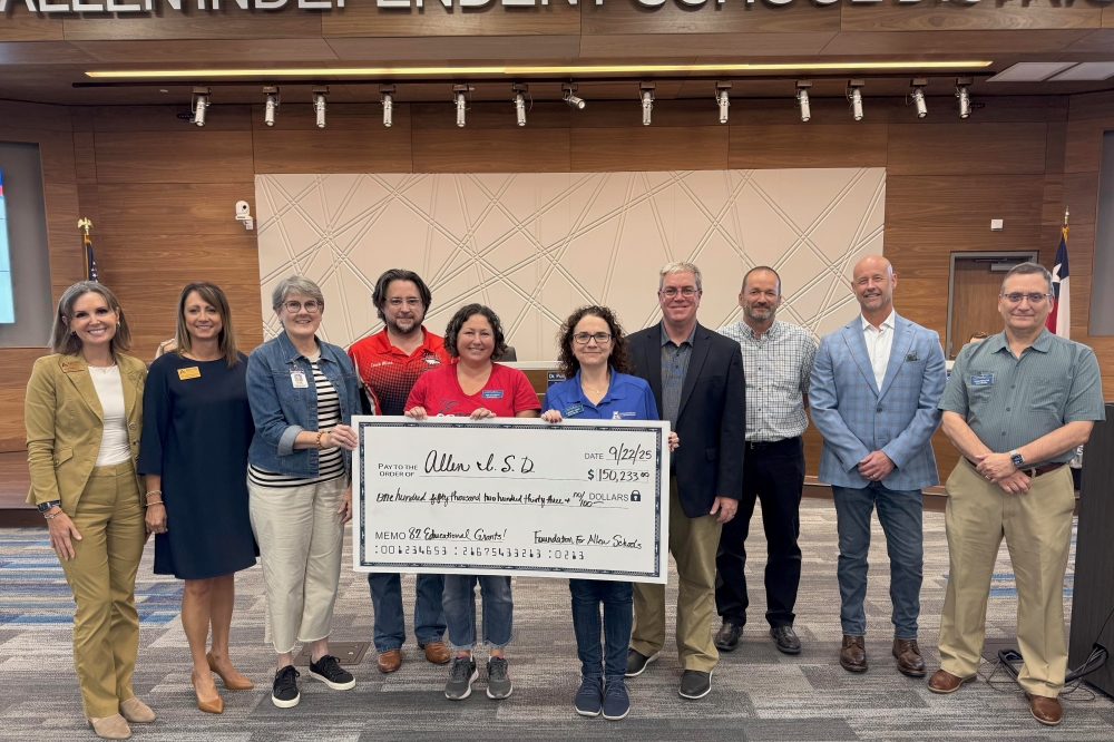 Image of Allen ISD and Foundation for Allen Schools officials posing with a big check for $150,233