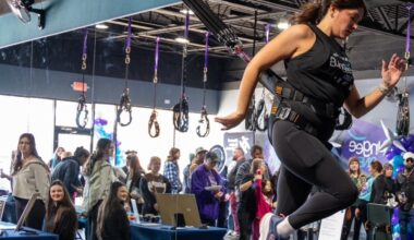 Onlookers watch someone doing bungee fitness.