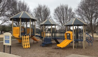 a playground with a yellow slide