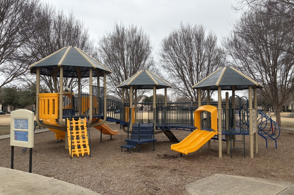 a playground with a yellow slide
