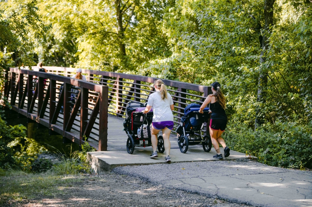 People walking on a trail with strollers