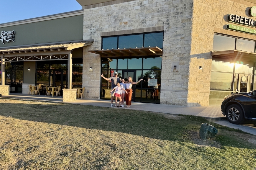 Owner Katie Walker poses with her family in front of the store. (Courtesy Drip Swag Shop)