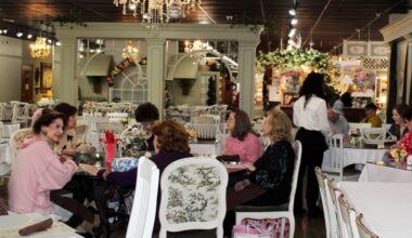 A table of women having conversations in a restaurant.