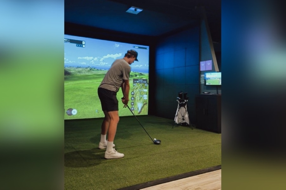 Image of a person teeing off at Tour Studio Golf