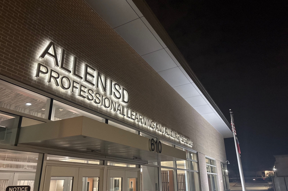 Image of entrance and sign for the Allen ISD professional learning and auxiliary services building.