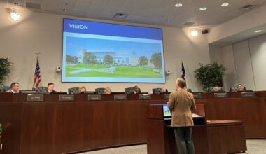 a man giving a presentation at a council meeiting