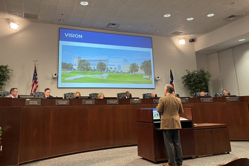 a man giving a presentation at a council meeiting