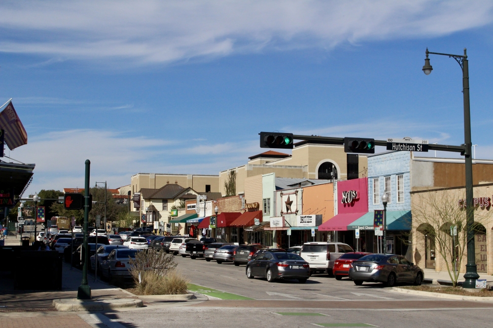 The streets of downtown San Marcos lined with parked cars.