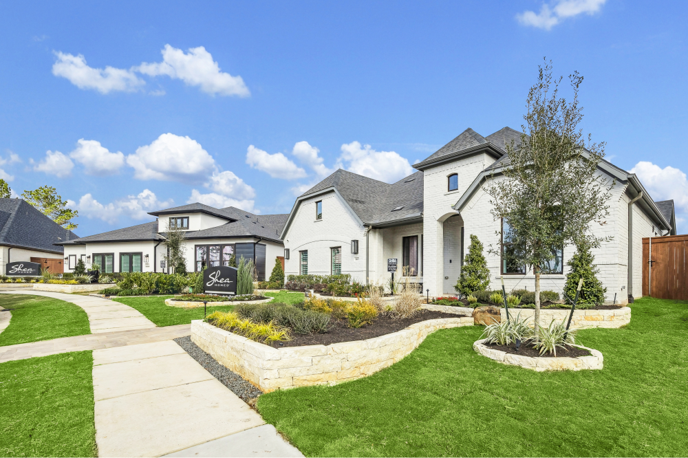 Front view of a Shea Homes Wildtree home in Magnolia Texas with spacious driveway, landscaped garden, and nature-focused community amenities