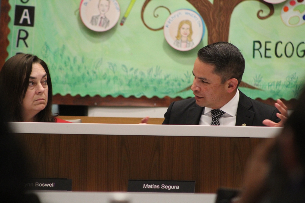 The superintendent talks at a board meeting