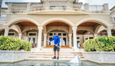 SPS PoolCare team member cleaning a pool