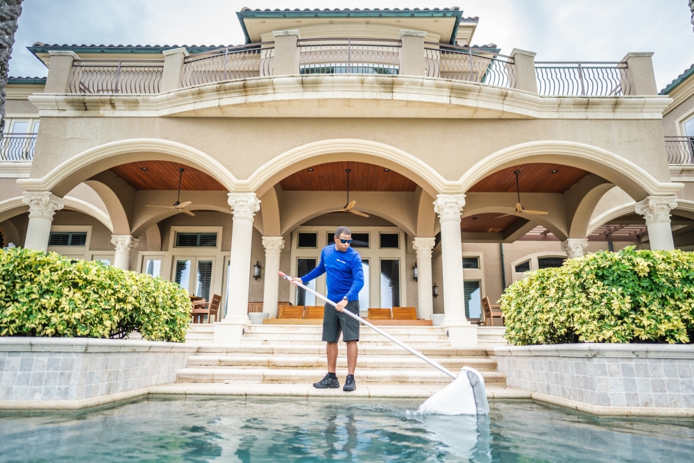 SPS PoolCare team member cleaning a pool