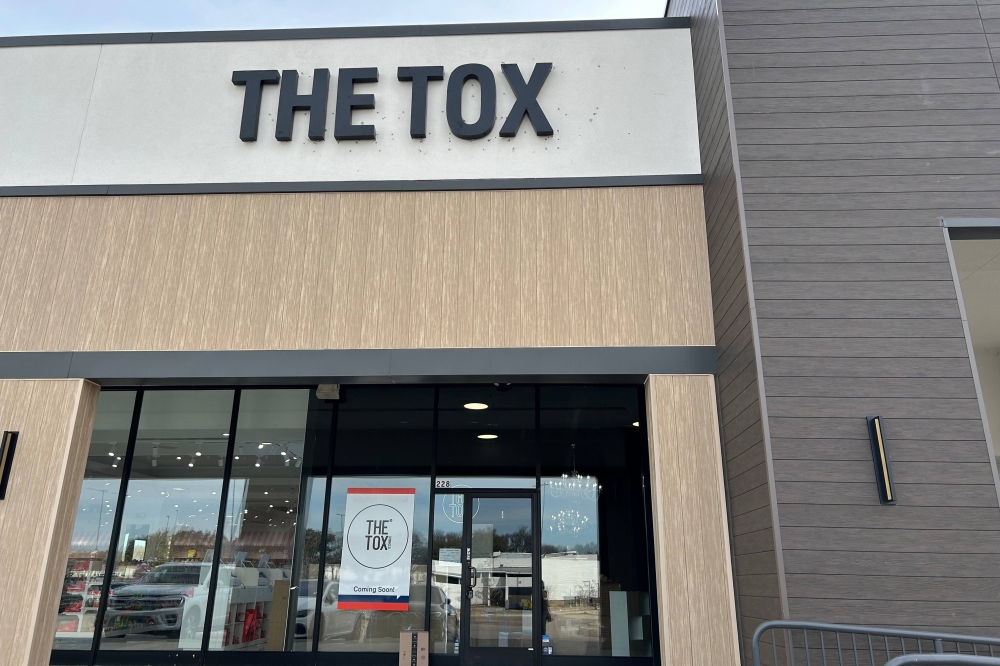 Exterior of a strip center featuring The Tox signage.