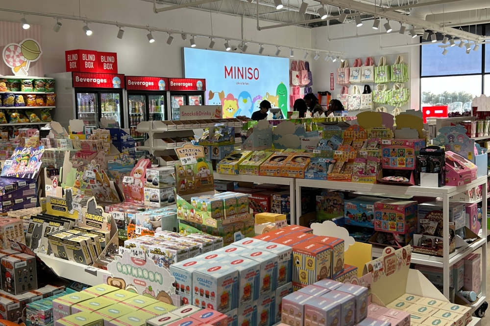 Products with asian writing displayed on shelves in a store.