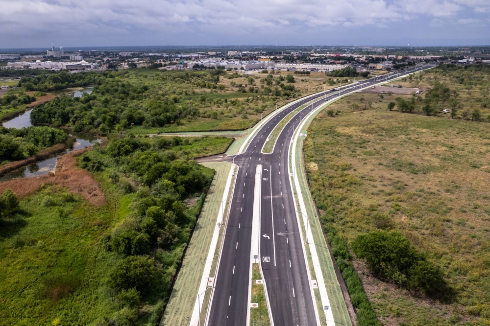 Aerial photo of Marketplace Avenue with green fields on both sides.