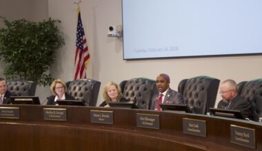 people sitting at a city council meeting