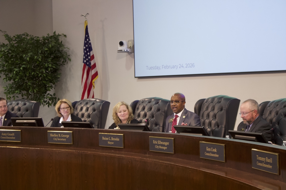 people sitting at a city council meeting