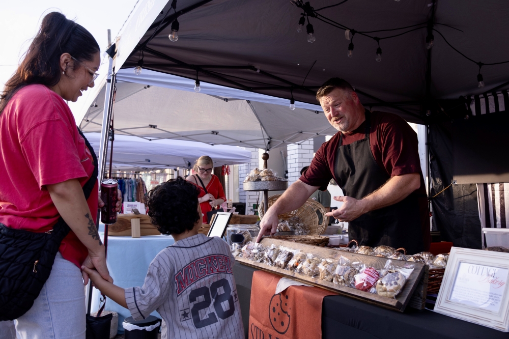 Strahan’s Bakehouse owner recommending a cookie to a young patron and his mom.