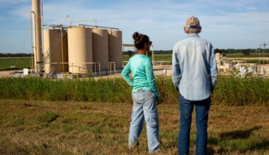 Blake Muir and his niece, Jennifer Sullivan, stand near a tank battery on his land in Gonzales County. Data shows it could come under nearly 15 feet of water in a 500-year flood. Credit: Dylan Baddour/Inside Climate News