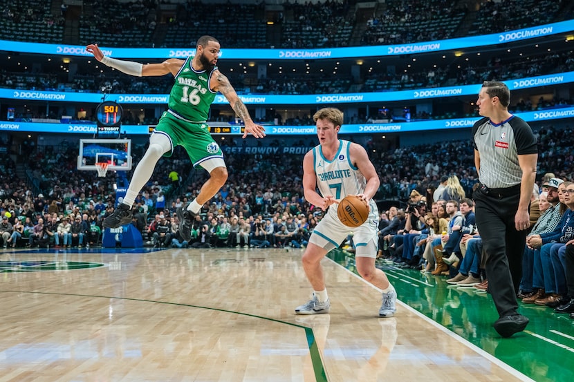 Charlotte Hornets guard Kon Knueppel (7) guards the ball against Dallas Mavericks forward...