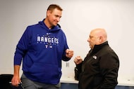 Texas Rangers executive vice president and general manager Chris Young, left, fist bumps...