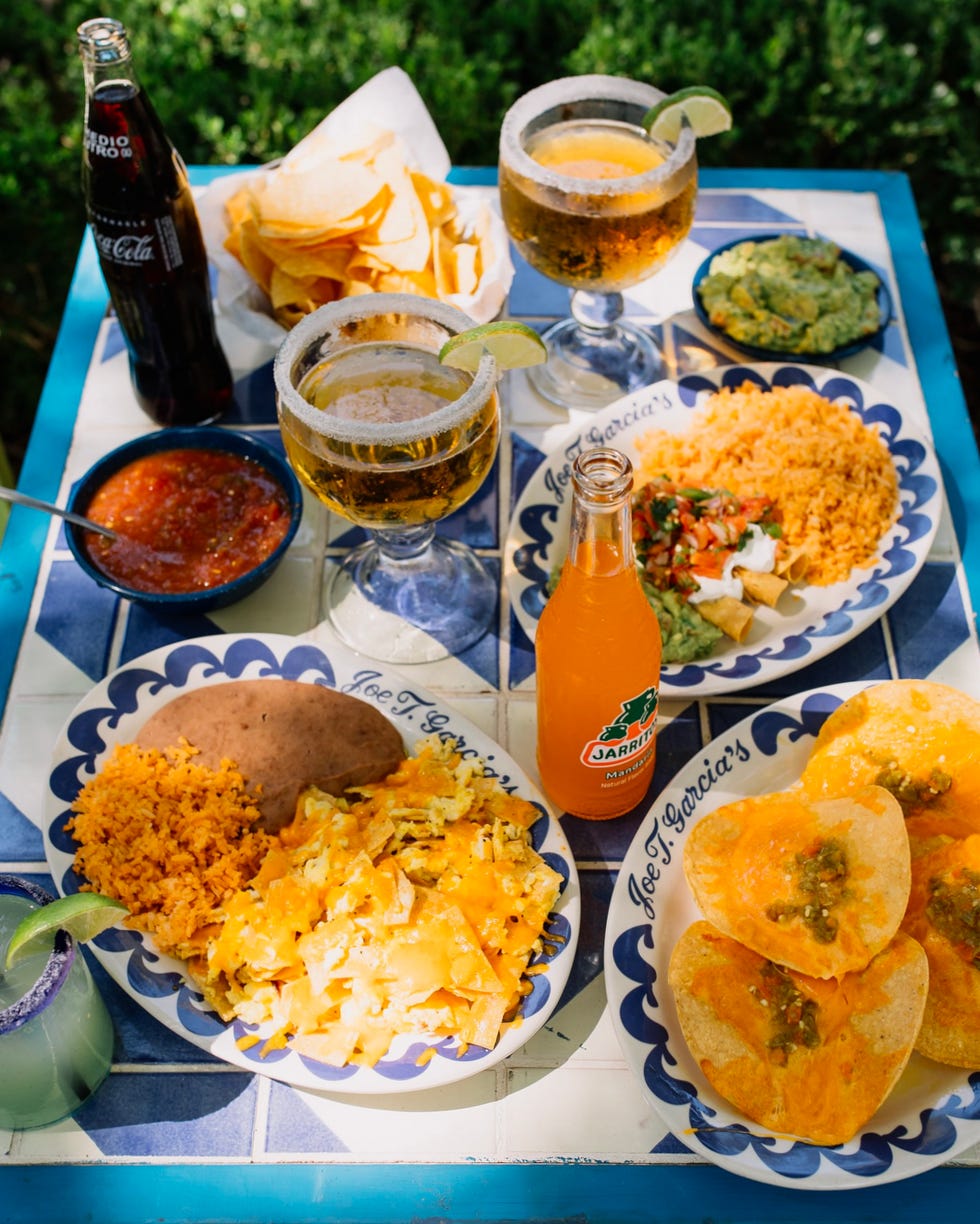 a table set with various mexican food items and drinks