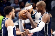 Dallas Mavericks forward Daniel Gafford (center) reacts after being called for a first half...