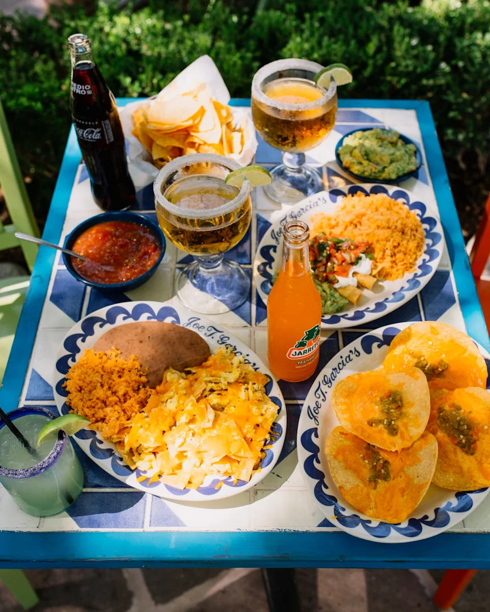 a table set with various mexican food items and drinks
