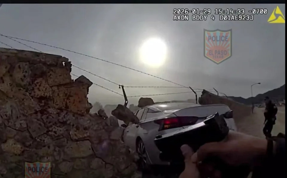 An image from an El Paso police body camera video shows as police officers approach a stolen car that crashed into a rock wall while attempting to flee on Apollo Avenue in Northeast El Paso on Jan. 29, 2026.